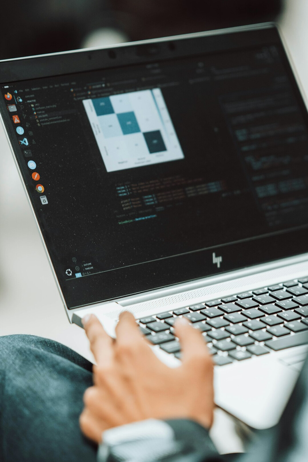 person coding on laptop
